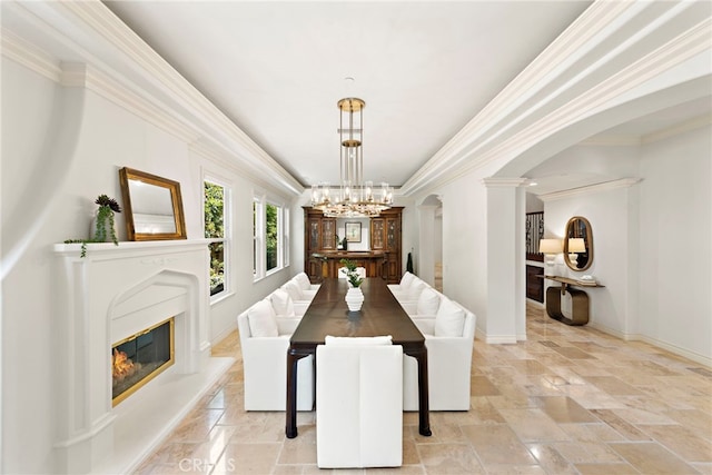 10 Corte Vizcaya, San Clemente, CA 92673 - dining space featuring arched walkways, ornate columns, baseboards, a chandelier, and a glass covered fireplace