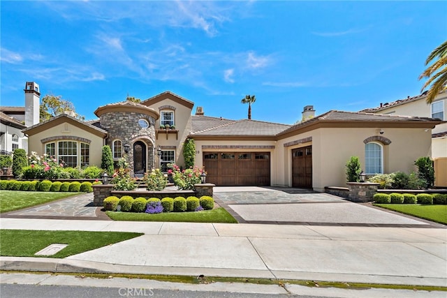 10 Corte Vizcaya, San Clemente, CA 92673 - mediterranean / spanish-style house featuring an attached garage, stucco siding, driveway, a tiled roof, and stone siding