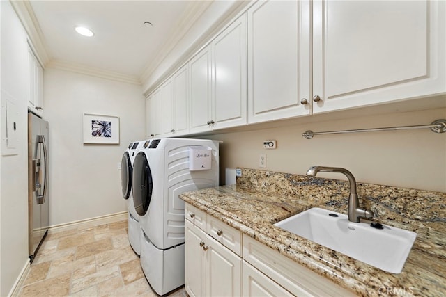 10 Corte Vizcaya, San Clemente, CA 92673 - laundry area featuring washing machine and clothes dryer, ornamental molding, cabinet space, light stone finish floors, and baseboards