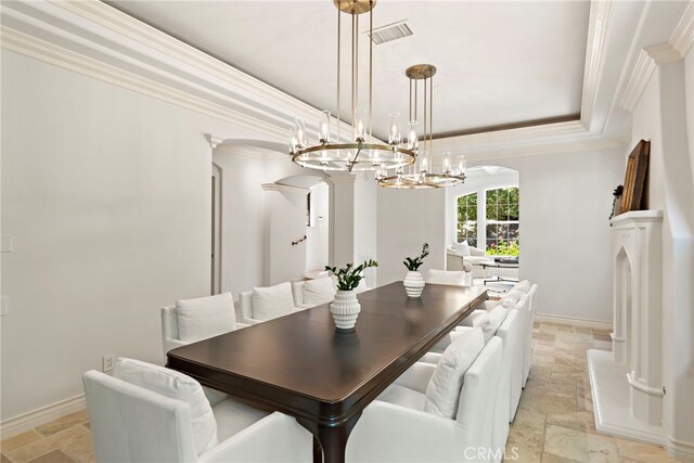 10 Corte Vizcaya, San Clemente, CA 92673 - dining space with stone tile floors, arched walkways, ornamental molding, a chandelier, and a raised ceiling