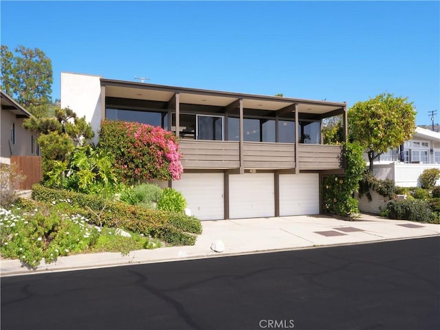 view of front of property with concrete driveway and an attached garage