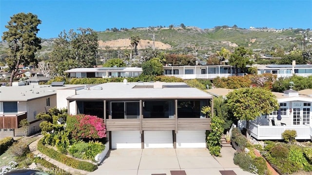 view of front of home featuring a mountain view, concrete driveway, and an attached garage