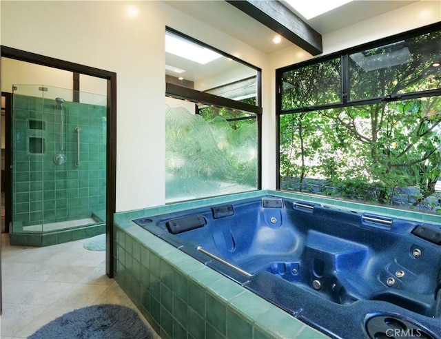 bathroom with tile patterned flooring, a shower stall, a tub with jets, and beam ceiling