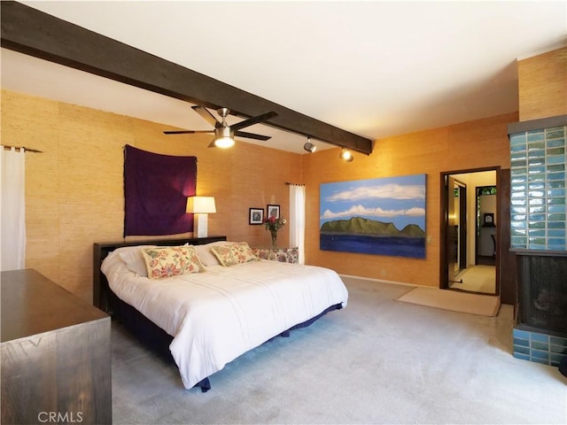 bedroom with beamed ceiling, carpet floors, and ceiling fan