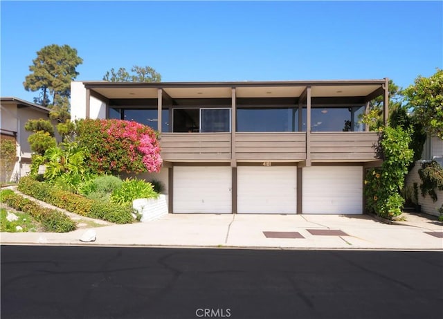 view of front of property featuring concrete driveway and an attached garage