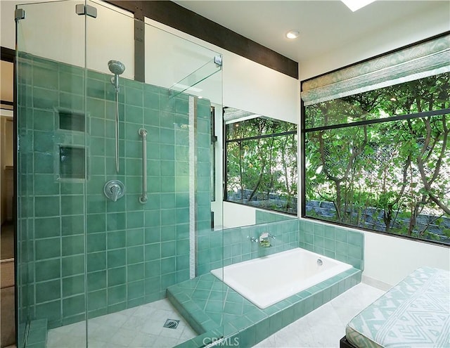 bathroom featuring a garden tub and a shower stall