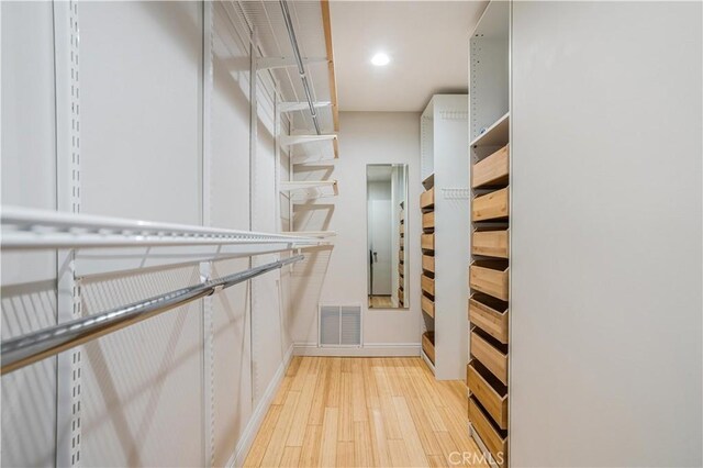 walk in closet with visible vents and light wood-type flooring