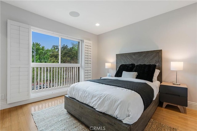 bedroom with recessed lighting, baseboards, and wood-type flooring