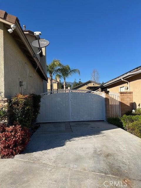 view of home's exterior featuring a gate, fence, and stucco siding