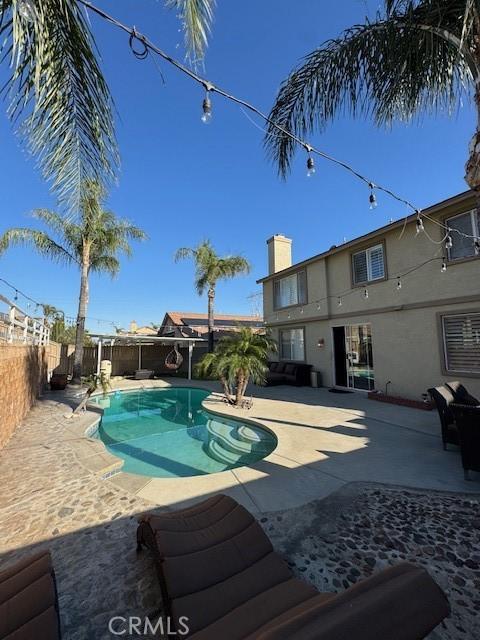 view of pool with a patio area, a fenced in pool, and a fenced backyard