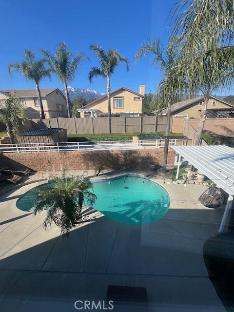 view of pool with a fenced in pool, a patio, and fence