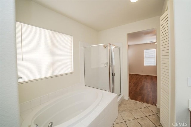 full bathroom with a bath, tile patterned flooring, and a shower stall
