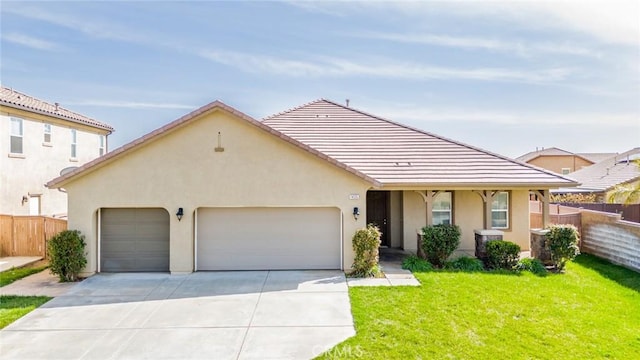 view of front facade with a front yard, stucco siding, fence, and an attached garage