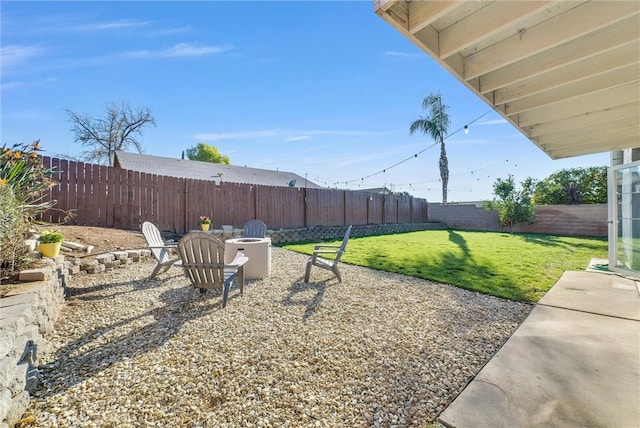 view of yard with a patio area, an outdoor fire pit, and a fenced backyard