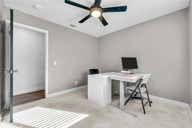 home office with visible vents, baseboards, carpet, and a ceiling fan