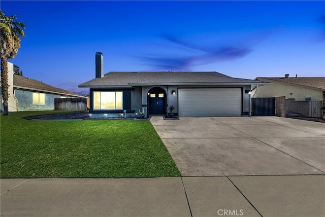 single story home with an attached garage, concrete driveway, a front yard, and fence