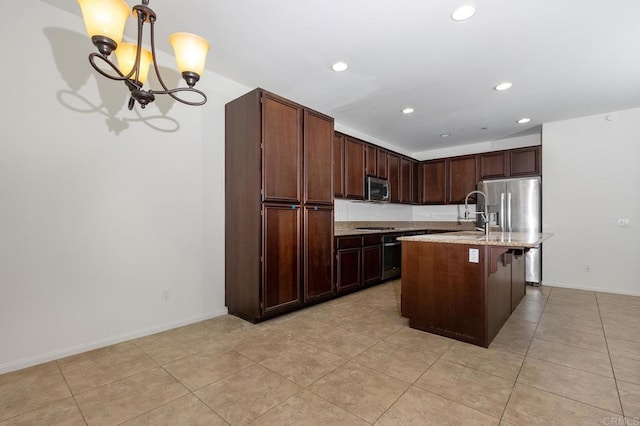 kitchen featuring baseboards, decorative light fixtures, recessed lighting, appliances with stainless steel finishes, and a notable chandelier