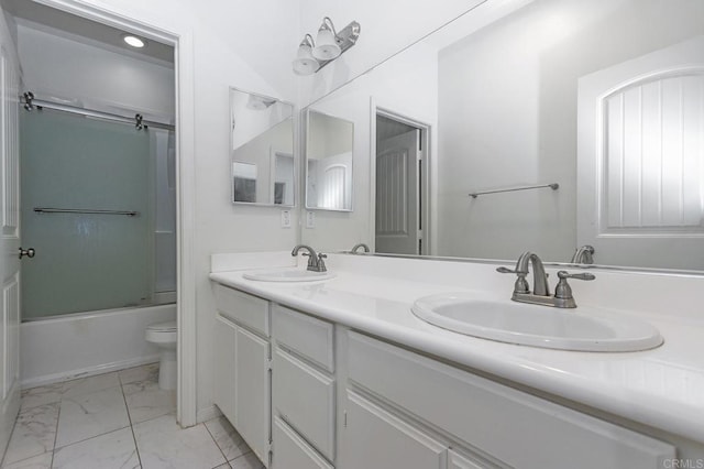 full bathroom with a sink, toilet, marble finish floor, and double vanity