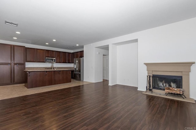 unfurnished living room featuring recessed lighting, visible vents, and light wood finished floors