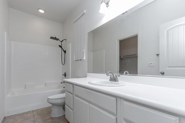 bathroom featuring tile patterned flooring, shower / washtub combination, toilet, and vanity