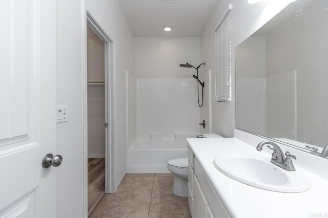 bathroom featuring tile patterned flooring, toilet, vanity, and  shower combination