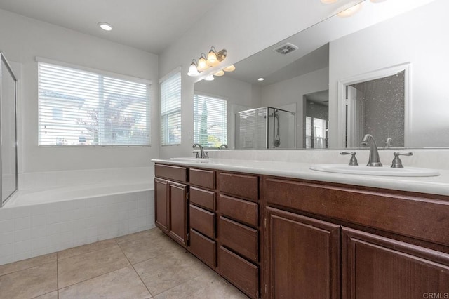 bathroom with a sink, visible vents, a stall shower, and tile patterned floors