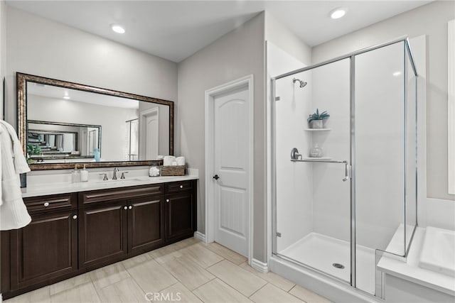 bathroom featuring vanity, a shower stall, and recessed lighting