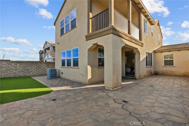 back of house featuring a patio area, central AC, and stucco siding