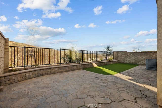 view of patio / terrace with cooling unit and a fenced backyard