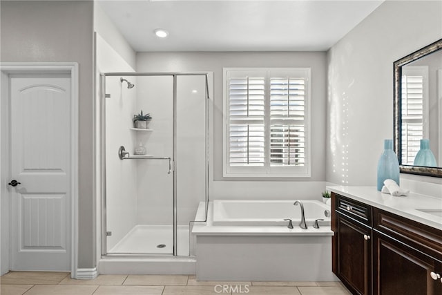 full bathroom featuring a wealth of natural light, a stall shower, and vanity