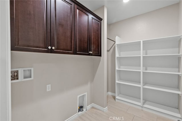 laundry area with hookup for a washing machine, cabinet space, baseboards, and electric dryer hookup