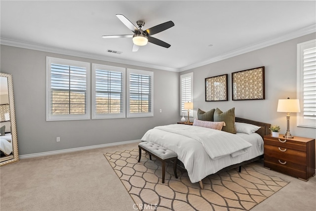 bedroom featuring visible vents, crown molding, baseboards, light colored carpet, and ceiling fan