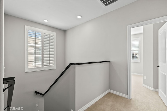 stairway featuring recessed lighting, visible vents, baseboards, and carpet