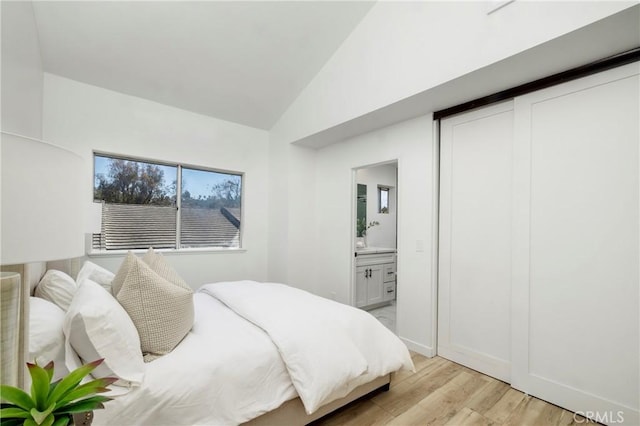 24877 Nueva Vista Dr Unit 23, Laguna Niguel, CA 92677 - bedroom with vaulted ceiling, light wood finished floors, and connected bathroom