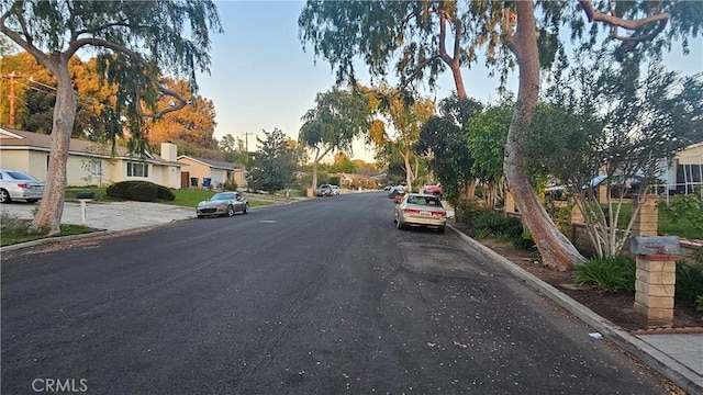 view of street with curbs and a residential view