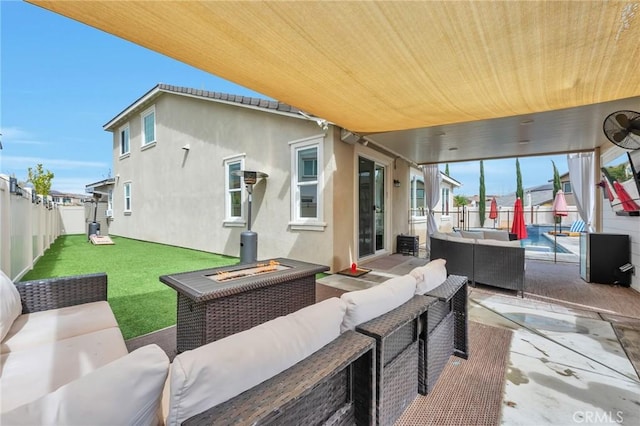 view of patio / terrace with an outdoor living space with a fire pit and a fenced backyard