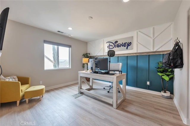 office area featuring light wood-type flooring, visible vents, and baseboards