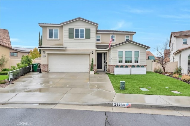 view of front of home featuring a front lawn, a tile roof, fence, concrete driveway, and a garage