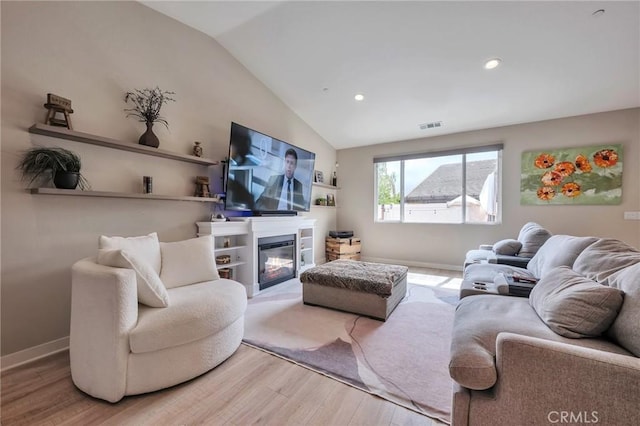 living area featuring wood finished floors, visible vents, baseboards, recessed lighting, and vaulted ceiling