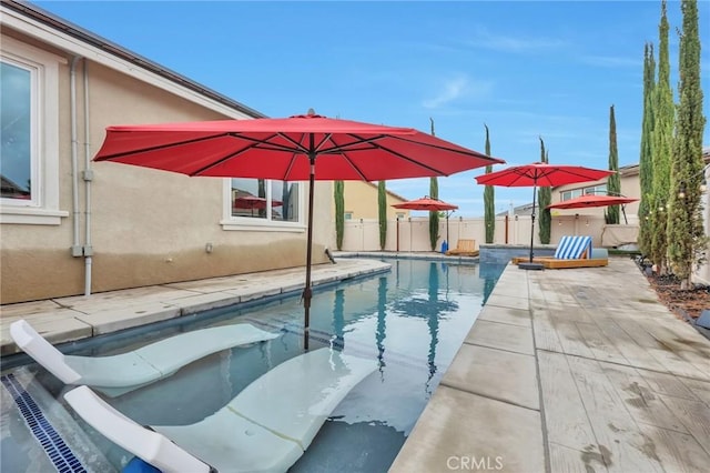 view of swimming pool featuring a patio area, a fenced in pool, and fence