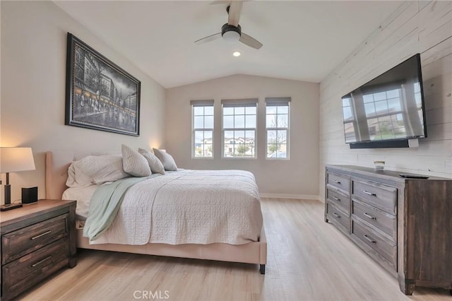 bedroom featuring vaulted ceiling, baseboards, light wood finished floors, and ceiling fan