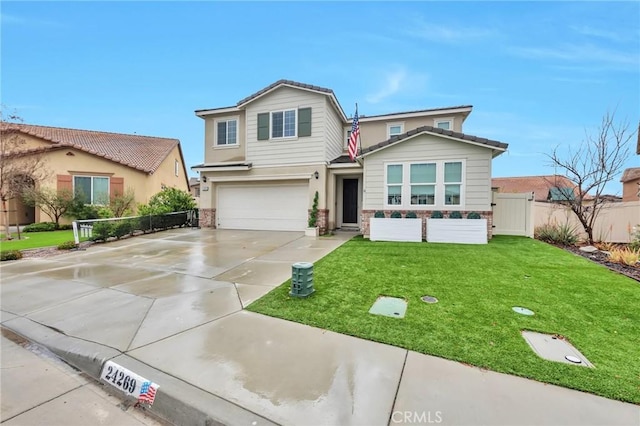 view of front facade featuring fence, driveway, a front lawn, stone siding, and a garage