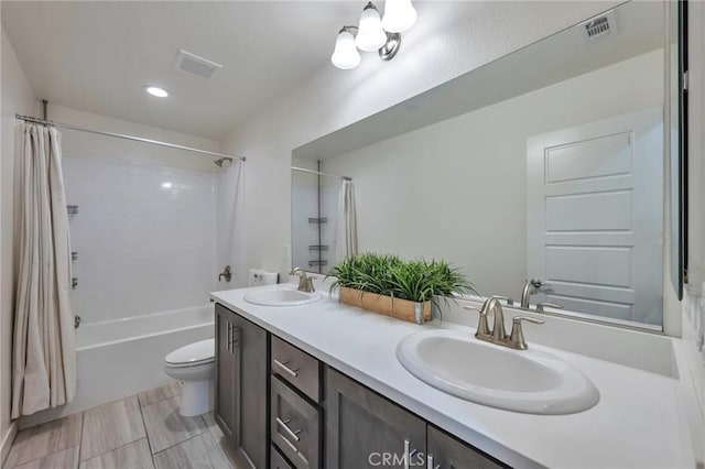 bathroom with a sink, visible vents, and toilet