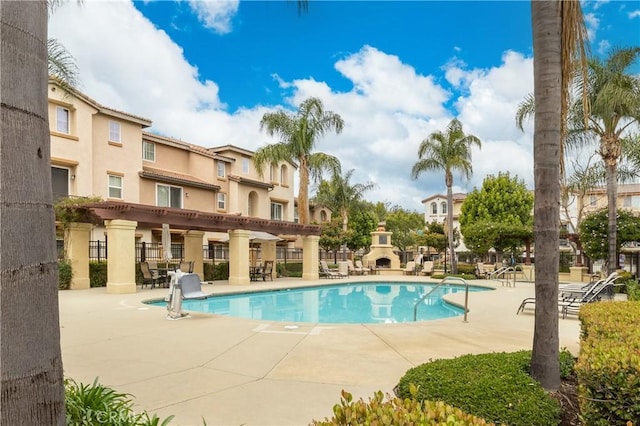 community pool featuring a patio area and fence