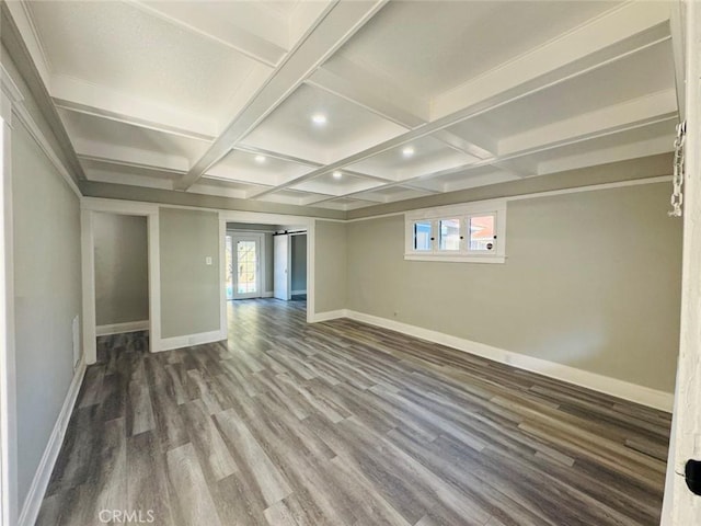 spare room with a healthy amount of sunlight, coffered ceiling, baseboards, and wood finished floors