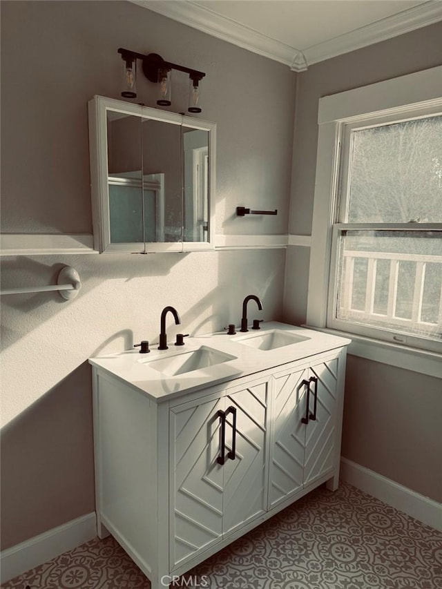 bathroom featuring crown molding, baseboards, and a sink