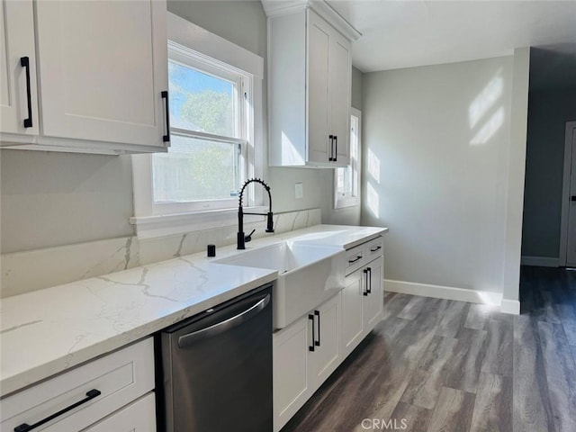 kitchen featuring light stone countertops, baseboards, a sink, white cabinets, and dishwasher