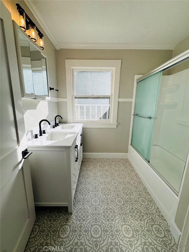 full bathroom featuring vanity, crown molding, baseboards, and shower / bath combination with glass door