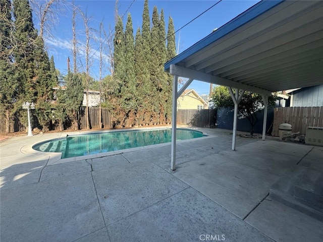 view of swimming pool with a fenced in pool, a fenced backyard, and a patio area