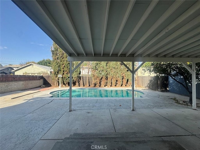 view of pool featuring a fenced in pool, a fenced backyard, and a patio area